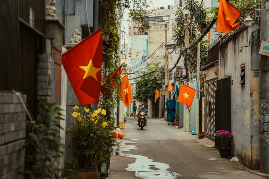 Man on a motorbike in a narrow street in Ho Chi Minh City in 2025