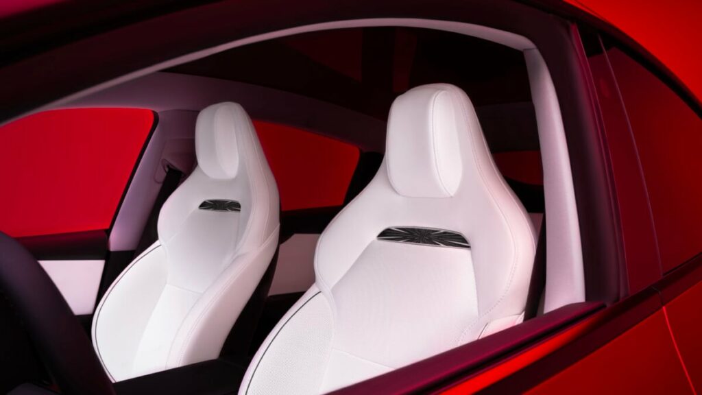 Intérieur Tesla Model Y Performance 2025 avec sièges sport, repose-genoux électriques et écran tactile de 16 pouces