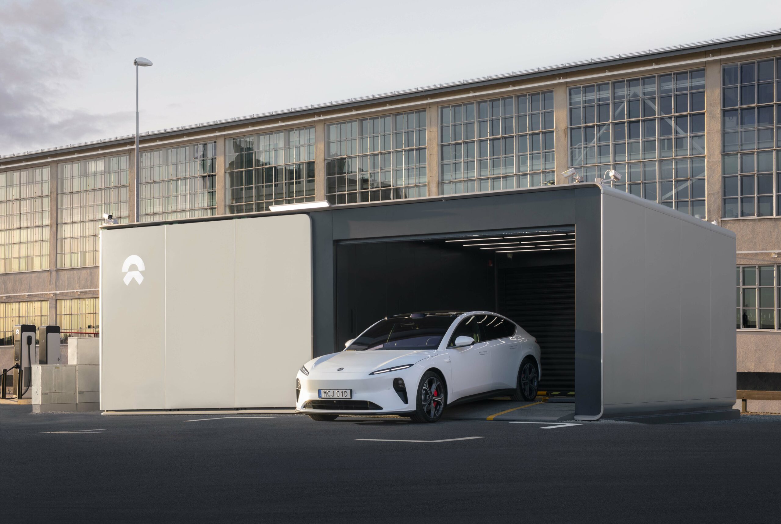 NIO electric car coming out of a Battery Swap station.