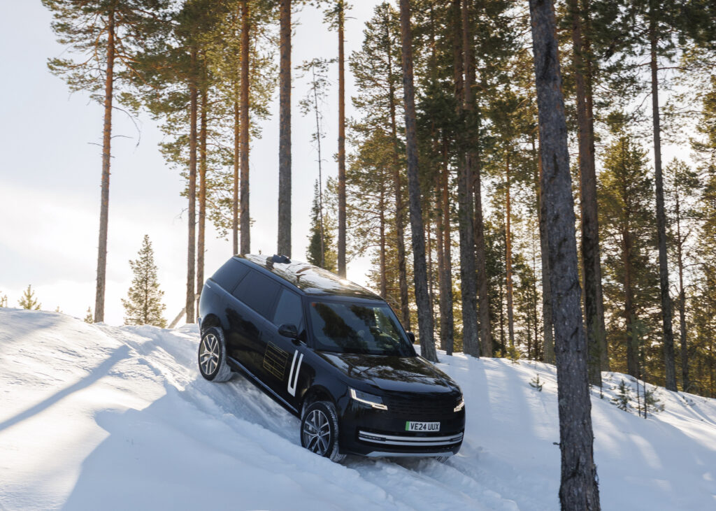 Range Rover Electric front view of a frozen snowy lake, 100% electric luxury SUV