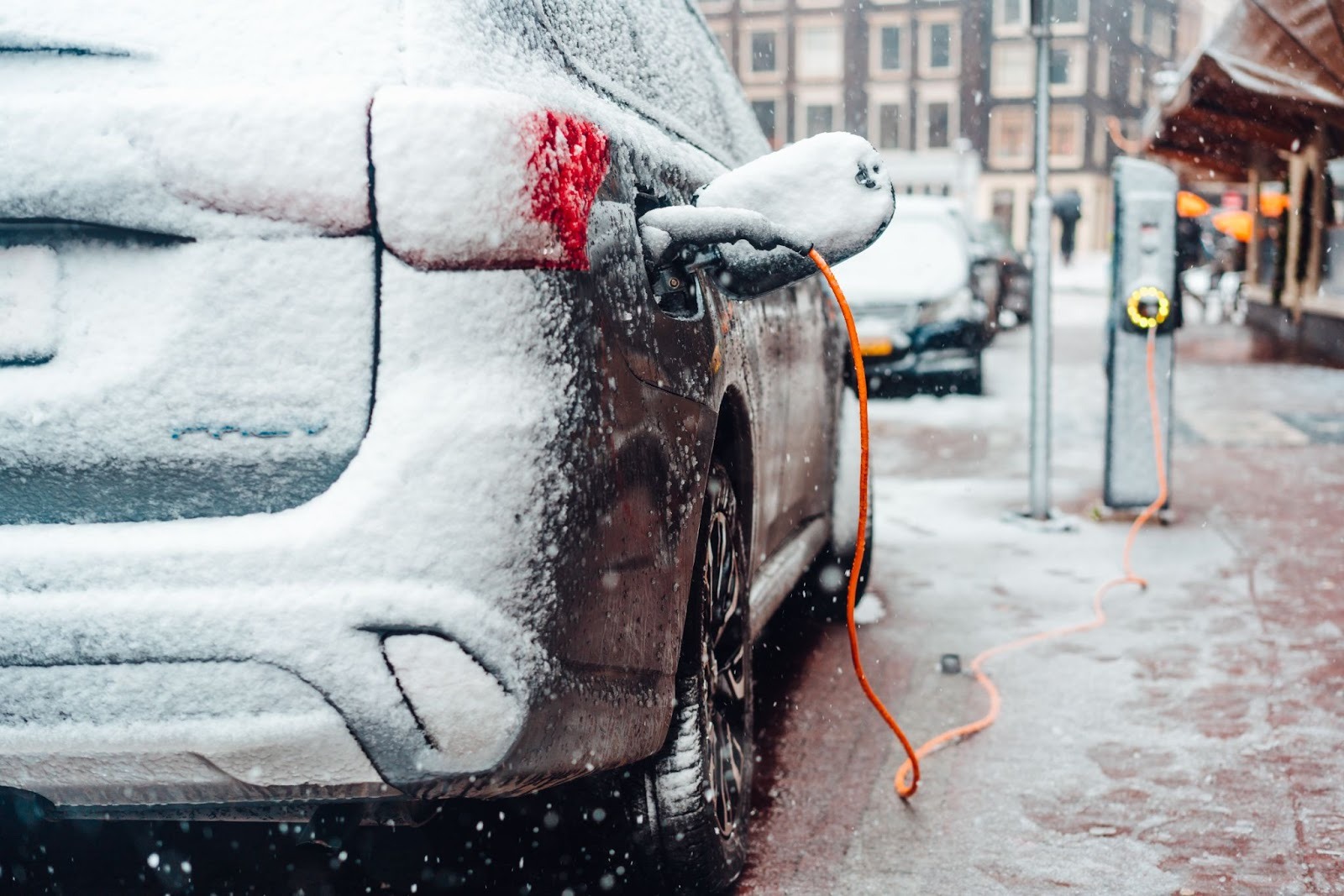 Electric car charging in the snow in the mountains