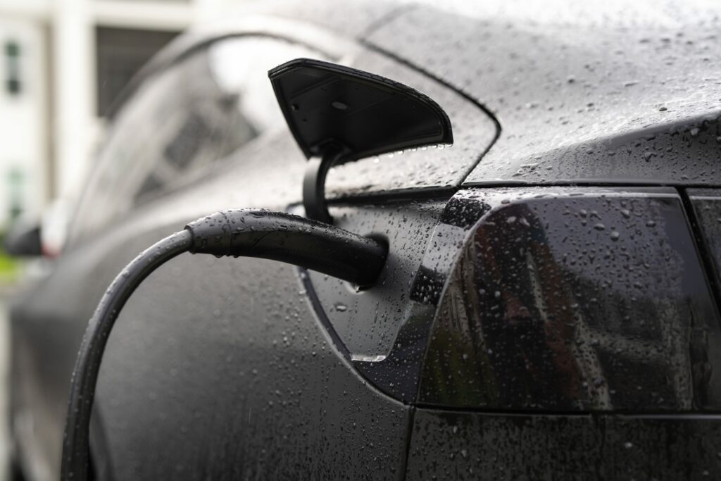 Electric car being charged at a modern public charging point, symbolising sustainable mobility in France