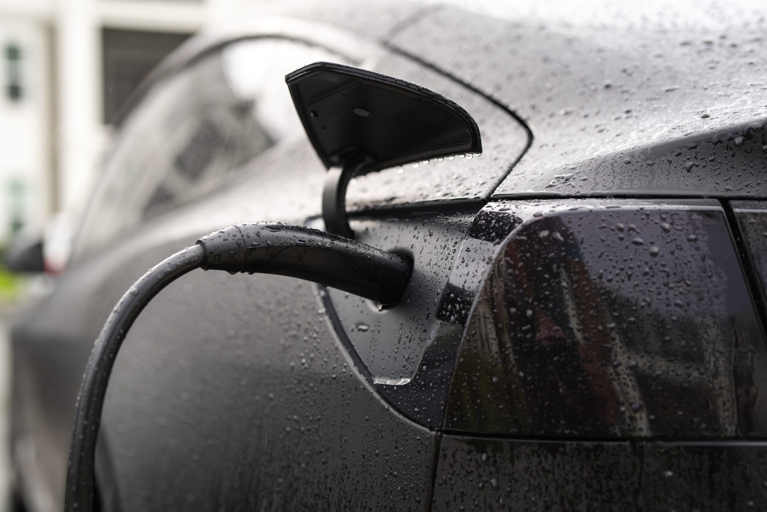 Electric car being charged at a modern public charging point, symbolising sustainable mobility in France