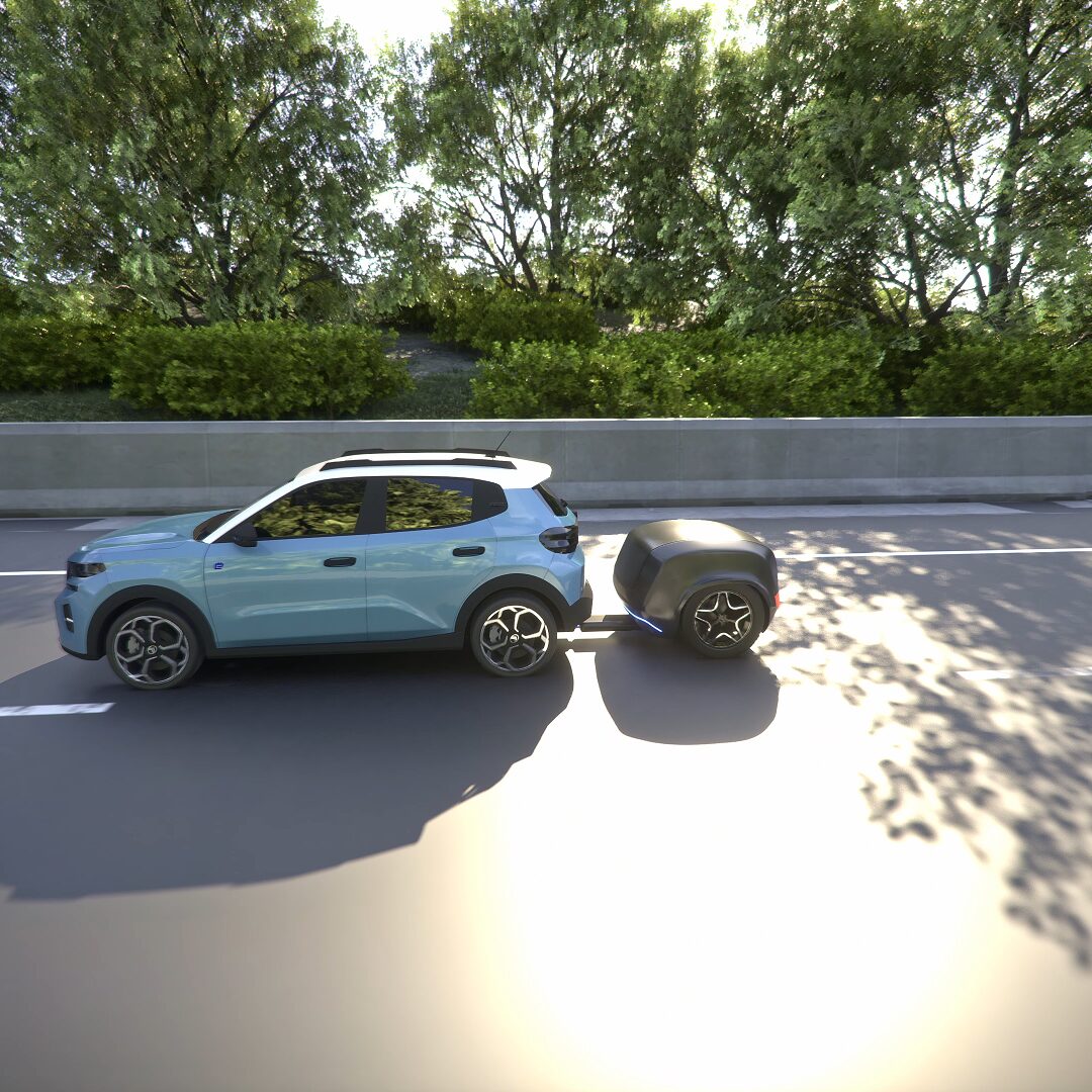 Electric car towing the Far-A-Day battery trailer on the motorway.